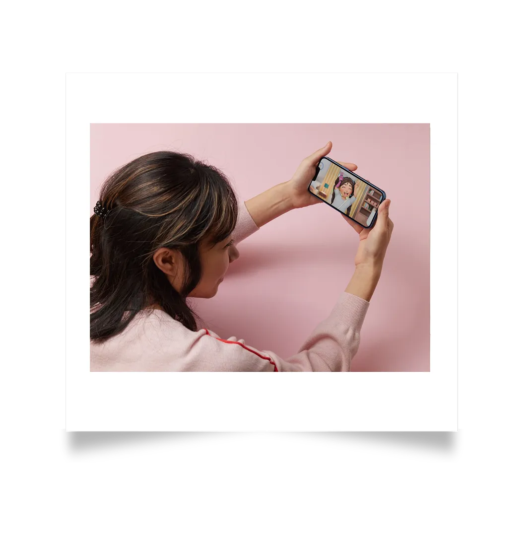Girl looking at the Sana character on a phone screen
